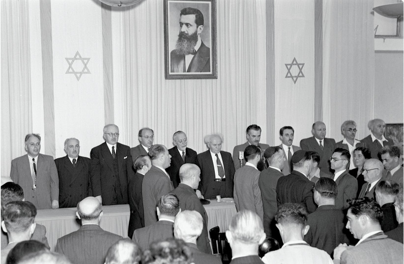 David Ben Gurion at the center as the state of Israel is declared May 14 1948 (credit: SCHERSCHEL FRANK/ GPO)