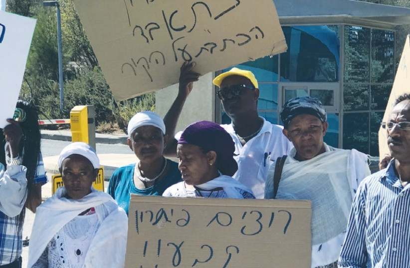 PROTESTING THE planned eviction of residents from the Mevaseret Zion absorption center, demonstrators hold signs, one of which reads ‘Without a solution, we will commit suicide,’ outside the Supreme Court (photo credit: Courtesy)