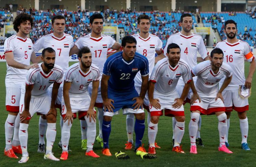 Syria's soccer team players pose for a photo before a friendly match against Vietnam. (photo credit: REUTERS)