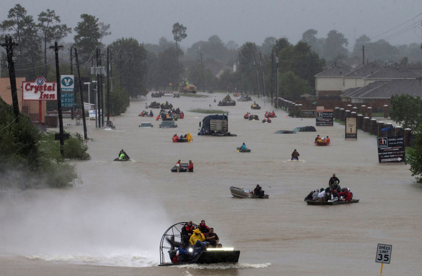 Residents use boats to evacuate flood waters from Tropical Storm Harvey along Tidwell Road east Houston, Texas (photo credit: REUTERS/ADREES LATIF)