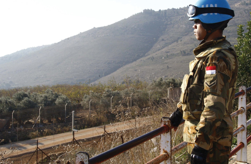 A PEACEKEEPER of the United Nations Interim Force in Lebanon (UNIFIL) stands at a lookout point in the village of Adaisseh near the Lebanese-Israeli border. (photo credit: REUTERS/KARAMALLAH DAHER)