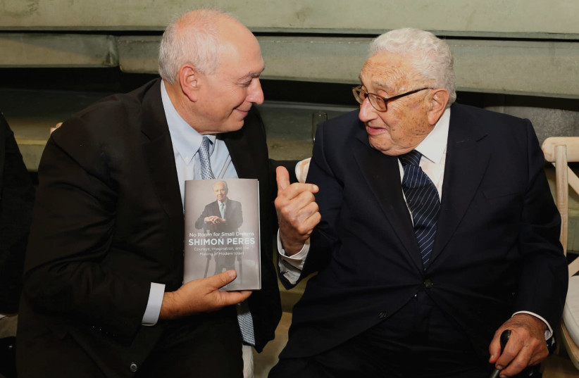 Chemi Peres (left) presents a copy of his father’s autobiography to Henry Kissinger. (photo credit: AVISHAG SHAR YASHUV)