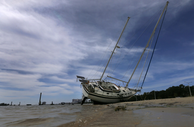 A sail boat is seen washed ashore after Hurricane Nate in Biloxi. (photo credit: REUTERS)