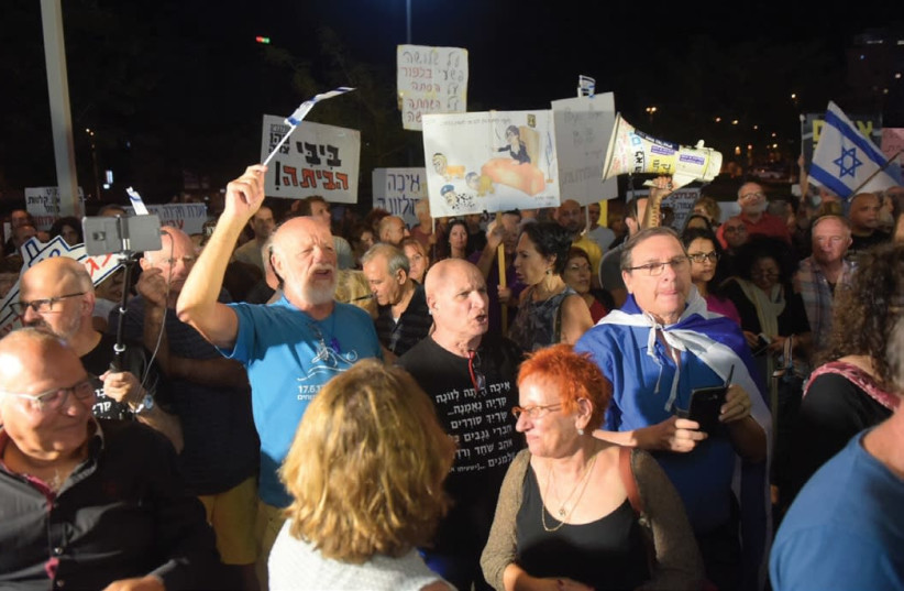 SOME 300 PEOPLE protest near Attorney-General Avichai Mandelblit’s home in Petah Tikva last night, calling on him to indict Prime Minister Benjamin Netanyahu on corruption  (photo credit: AVSHALOM SASSONI)