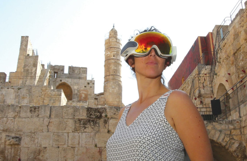 A visitor gazes at a different reality, yesterday at the Tower of David Museum of the History of Jerusalem. (photo credit: MARC ISRAEL SELLEM/THE JERUSALEM POST)
