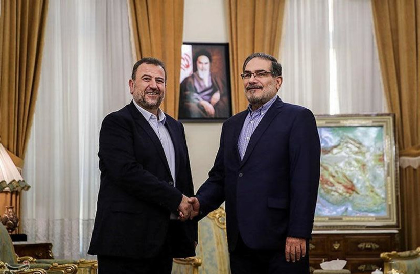 Saleh al-Arouri (L), Hamas deputy chief, shakes hands with Ali Shamkhani, secretary of Iran's National Security Council, during their meeting in Tehran, Iran October 21, 2017. (credit: TASNIM NEWS AGENCY/HANDOUT VIA REUTERS)