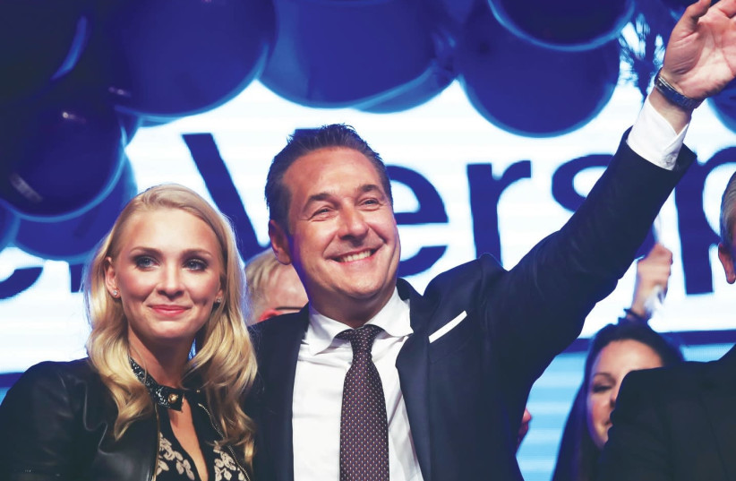 Heinz-Christian Strache, the head of the far-right Freedom Party, celebrates in Vienna with his wife, Phillipa Beck, after Austria's general election (photo credit: MICHAEL DALDER/REUTERS)