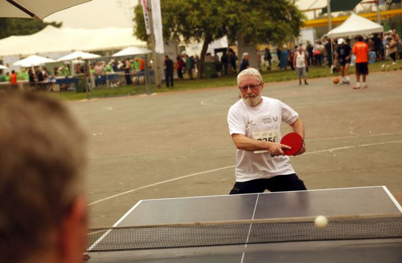 Senior Israelis play table tennis as they take part in games for people over 65 years old, organized by a nursing home in Tel Aviv (photo credit: BAZ RATNER/REUTERS)