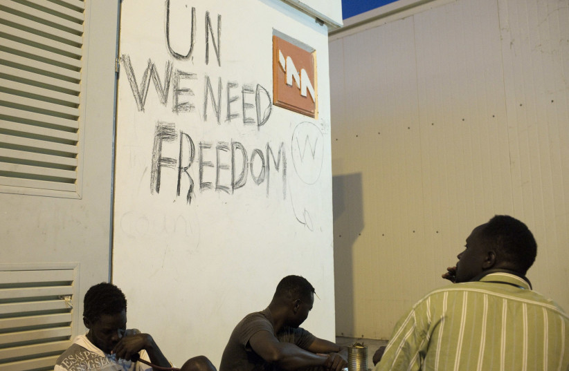 African migrants sit at the Holot open detention center in the Negev in Southern Israel (photo credit: FINBARR O'REILLY / REUTERS)