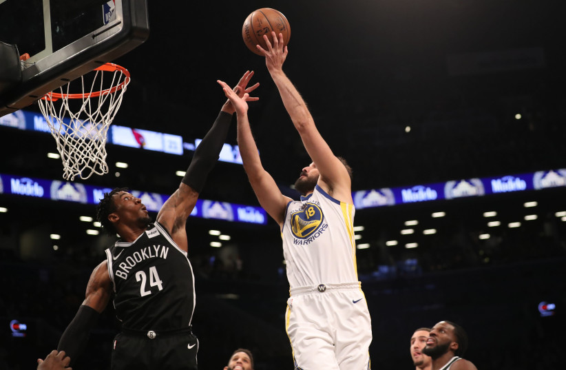Golden State Warriors forward Omri Casspi shoots over Brooklyn Nets forward Rondae Hollis-Jefferson during the first quarter at Barclays Center.  (photo credit: ANTHONY GRUPPUSO-USA TODAY VIA REUTERS)