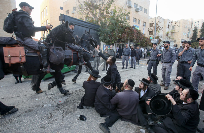 Haredi men protest outside the draft office in Jerusalem on November 28. (photo credit: MARC ISRAEL SELLEM)