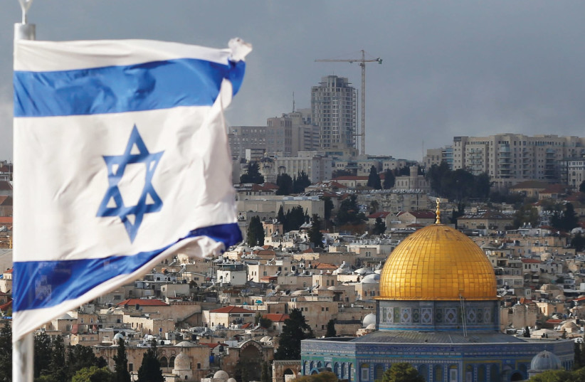 AN ISRAELI flag near the Dome of the Rock in Jerusalem’s Old City. (photo credit: REUTERS)