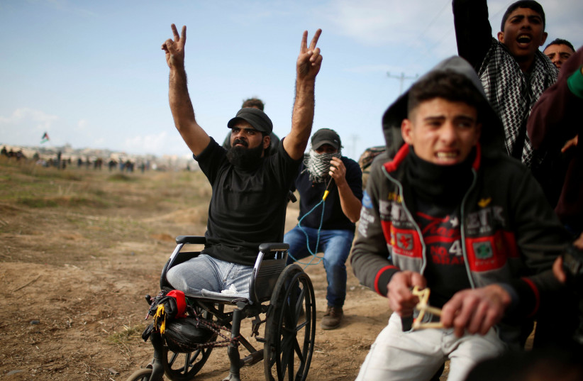Ibraheem Abu Thuraya gestures during a protest against US President Donald Trump's decision to recognize Jerusalem as the capital of Israel, near the border with Israel in the east of Gaza City, December 15, 2017.  (photo credit: REUTERS)