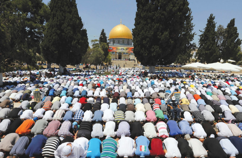 MUSLIMS PRAY next to Al-Aqsa Mosque in Jerusalem. (photo credit: REUTERS)