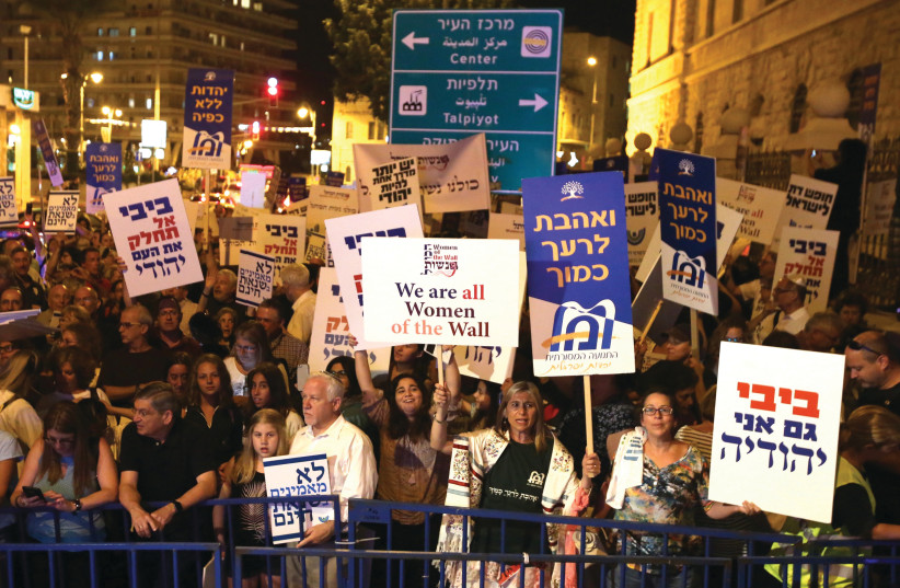 ACTIVISTS TAKE part in a demonstration in Jerusalem in July against legislation that would have strengthened the Chief Rabbinate’s monopoly over conversion in Israel (photo credit: MARC ISRAEL SELLEM)