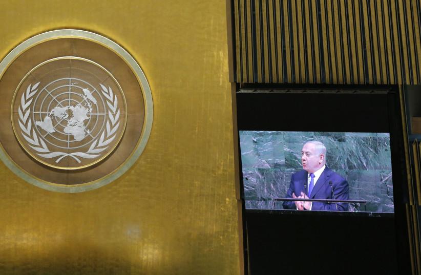 Israeli Prime Minister Benjamin Netanyahu is shown on a large screen as he addresses the 72nd United Nations General Assembly at UN headquarters in New York, US, September 19, 2017.  (photo credit: REUTERS)