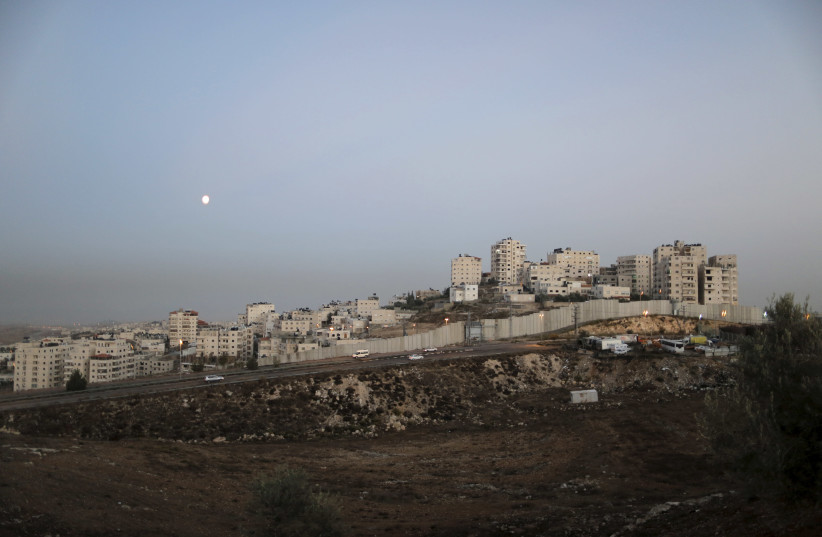 A general view picture shows the Israeli barrier running along the East Jerusalem refugee camp of Shuafat (photo credit: REUTERS)