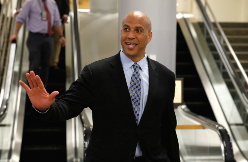 US SENATOR Cory Booker waves after Senate Republicans unveiled their version of legislation that would replace Obamacare on Capitol Hill in Washington. (photo credit: REUTERS)