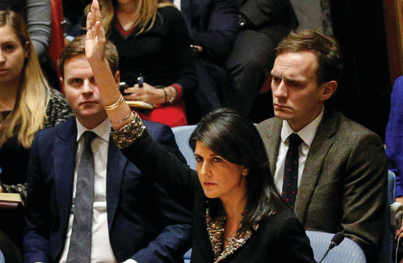US Ambassador Nikki Haley vetoes the Egyptian-drafted resolution on the status of Jerusalem at the UN Security Council meeting on December 18 (photo credit: BRENDAN MCDERMID/REUTERS)
