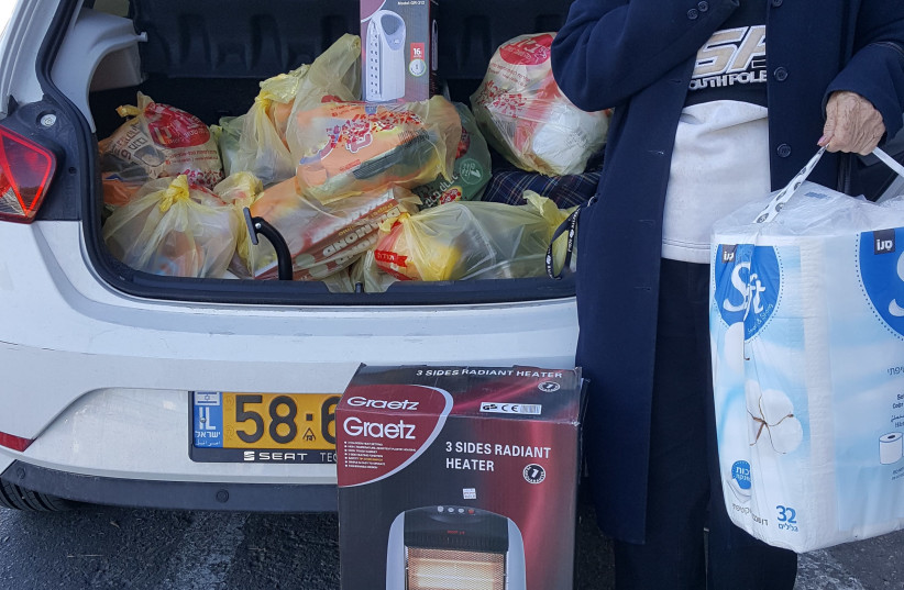 Alexandra, a Holocaust survivor, with groceries purchased for her by the Association for the Immediate Help for Holocaust Survivors (photo credit: THE ASSOCIATION FOR IMMEDIATE HELP FOR HOLOCAUST SURVIVORS)