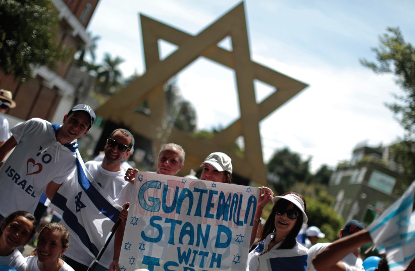 Guatemalan activists wave Israeli flags near the "Plaza of Israel" in the country's capital, 2015 (photo credit: REUTERS)