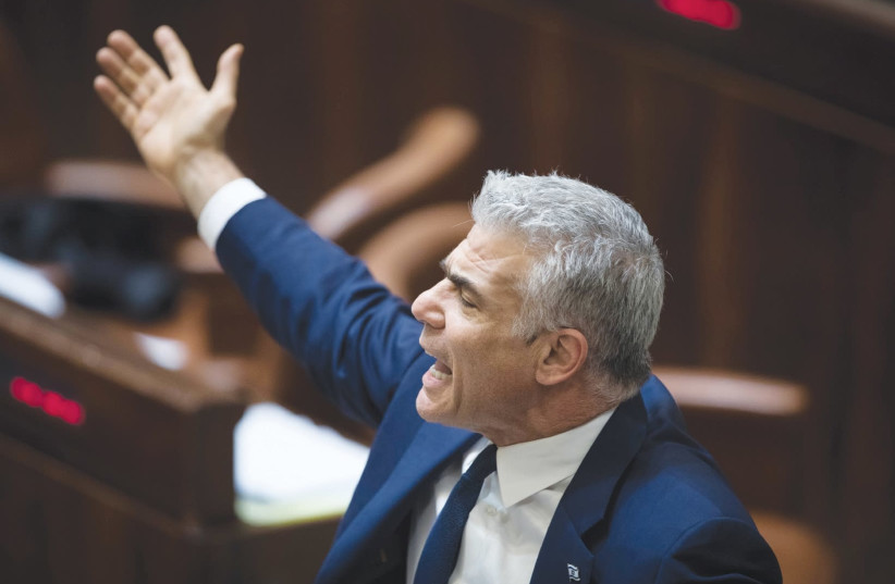 Yesh Atid chairman Yair Lapid declaims during the filibuster on Wednesday night, ahead of the Knesset vote on the Police Recommendations Bill (photo credit: HADAS PARUSH/FLASH90)