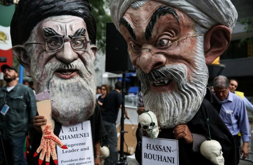 Iranian Americans and opponents of Iranian President Hassan Rouhani hold protests outside of UN headquarters on the day Rouhani addresses the General Assembly of the United Nations in New York, US, September 20, 2017. (File Photo) (photo credit: REUTERS/AMR ALFIKY)