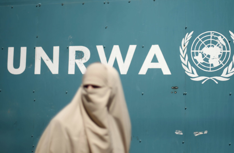 A Palestinian woman takes part in a protest against possible reductions of the services and aid offered by United Nations Relief and Works Agency (UNRWA), in front of UNRWA headquarters in Gaza City August 16, 2015. (photo credit: REUTERS/MOHAMMED SALEM)
