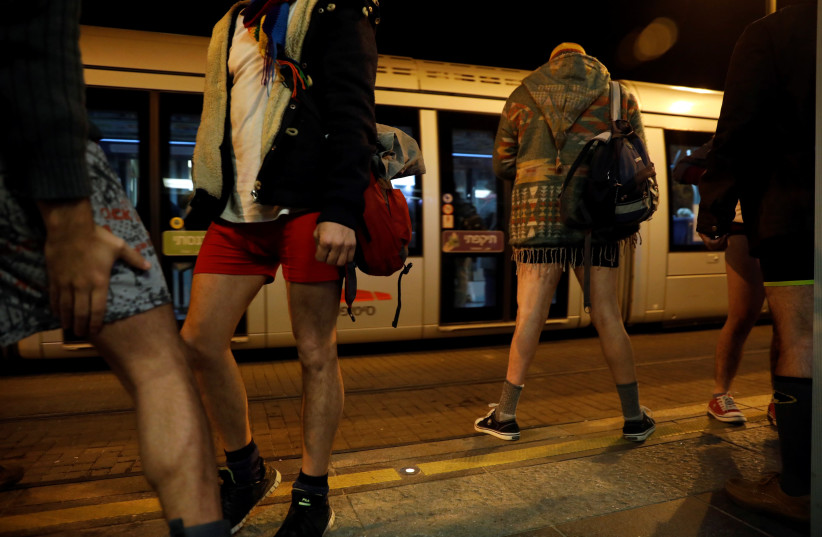 Israelis take part in the annual No Pants Day on Jerusalem's Light Rail, January 2018 (photo credit: RONEN ZVULUN/ REURERS)