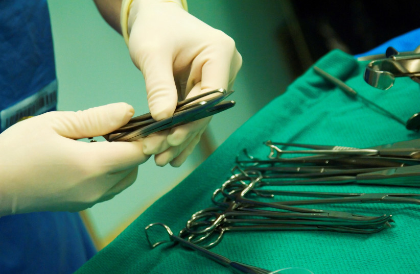 Surgeon selecting sterilized tool for operation. (photo credit: INGIMAGE)