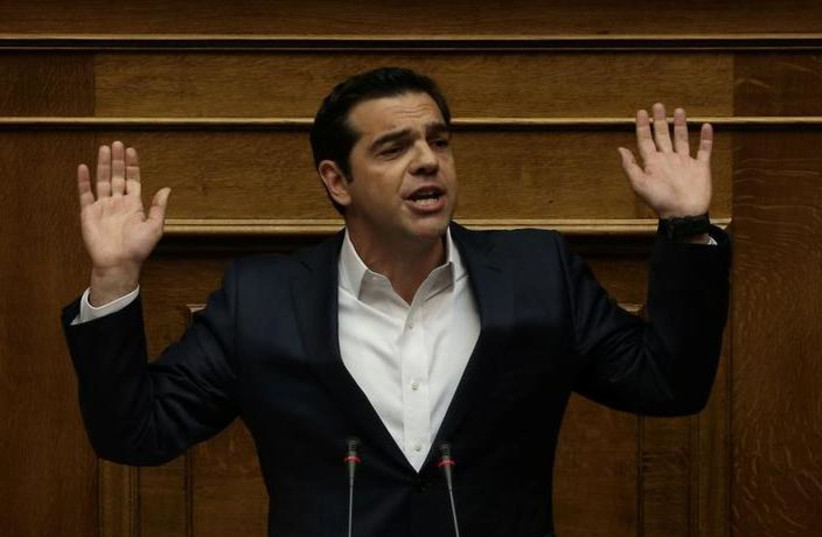 Greek Prime Minister Alexis Tsipras gestures as he addresses lawmakers before a parliamentary vote in Athens, Greece, May 18, 2017. (photo credit: ALKIS KONSTANTINIDIS / REUTERS)
