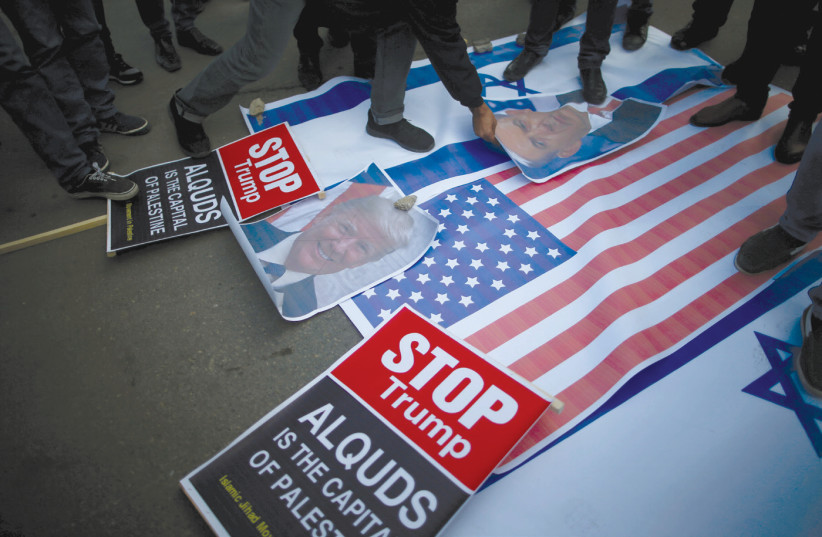 PROTESTERS IN Gaza City begin stomping on posters depicting Prime Minister Benjamin Netanyahu and US President Donald Trump and Israeli and American flags before burning them during a protest following Trump’s recognition of Jerusalem as the capital of Israel. (credit: MOHAMMED SALEM/REUTERS)