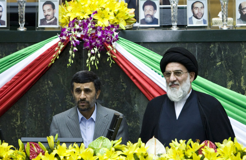 Iran's President Mahmoud Ahmadinejad (L) reads the oath of office as Judiciary Chief Mahmoud Hashemi Shahroudi looks on during Ahmadinejad's swearing-in ceremony in Tehran August 5, 2009. (photo credit: REUTERS)