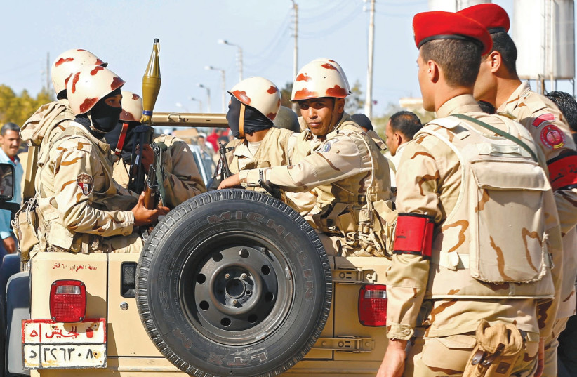 EGYPTIAN MILITARY forces look on in the northern Sinai. (photo credit: MOHAMED ABD EL GHANY/REUTERS)