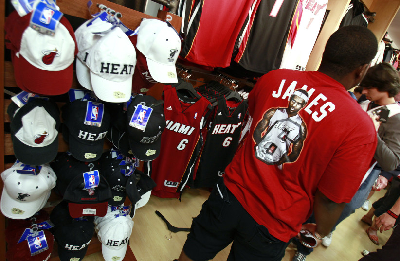 A basketball fan wearing a LeBron James T-shirt at the NBA store in Miami. (photo credit: REUTERS)