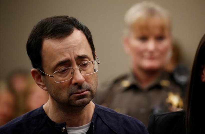 Larry Nassar, a former team USA Gymnastics doctor who pleaded guilty in November 2017 to sexual assault charges, stands during his sentencing hearing in Lansing, Michigan, US, January 24, 2018.  (photo credit: BRENDAN MCDERMID/REUTERS)