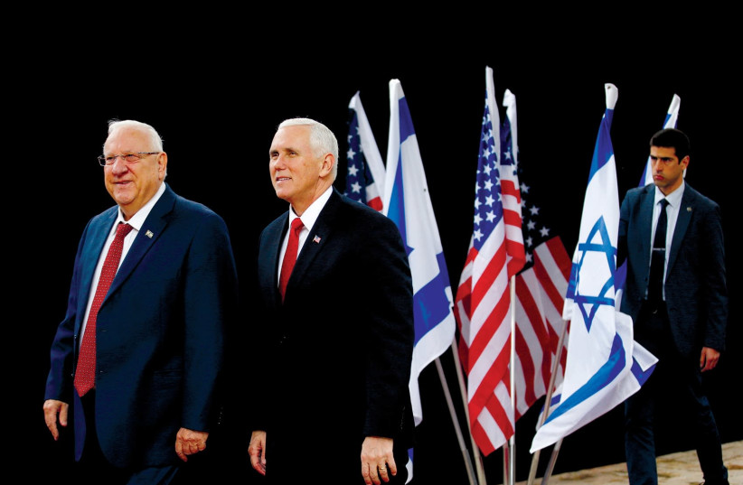 US VICE President Mike Pence walks alongside President Reuven Rivlin during a formal reception ceremony at Beit Hanassi on Tuesday. (Ronen Zvulun/Reuters). (photo credit: RONEN ZVULUN/REUTERS)
