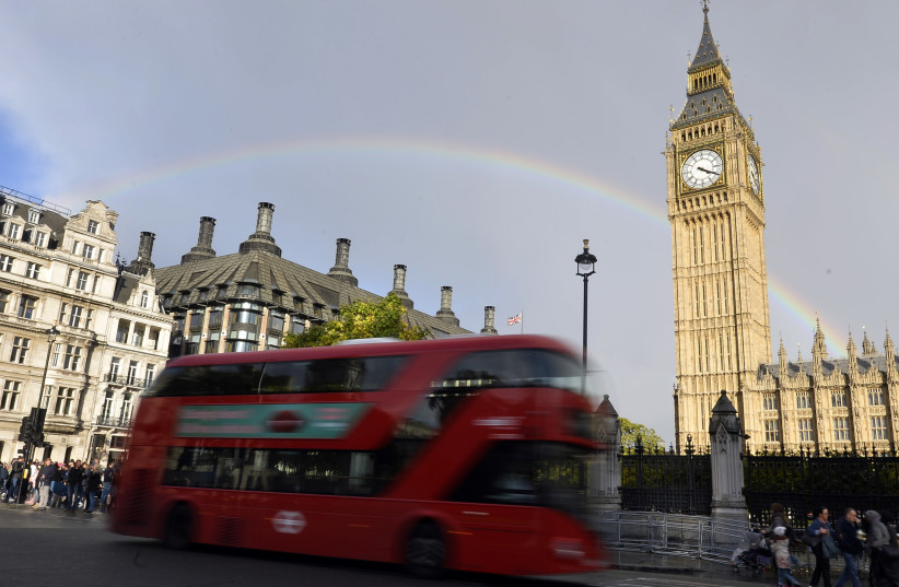 A rainbow is seen behind the Big Ben clock tower, at the Houses of Parliament in central London, Britain, October 16, 2016. (photo credit: REUTERS)