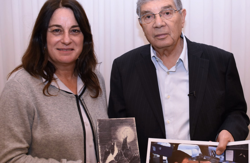 Rona Ramon holding a picture of Ilan Ramon with a copy of the "Moon Landscape" before his mission to space in 2003; also in the picture NASA Astronaut Tom Marsburn and his wife Ann, who are attending the Israel Space Week events. (photo credit: DANIEL BABCZYK/YAD VASHEM)