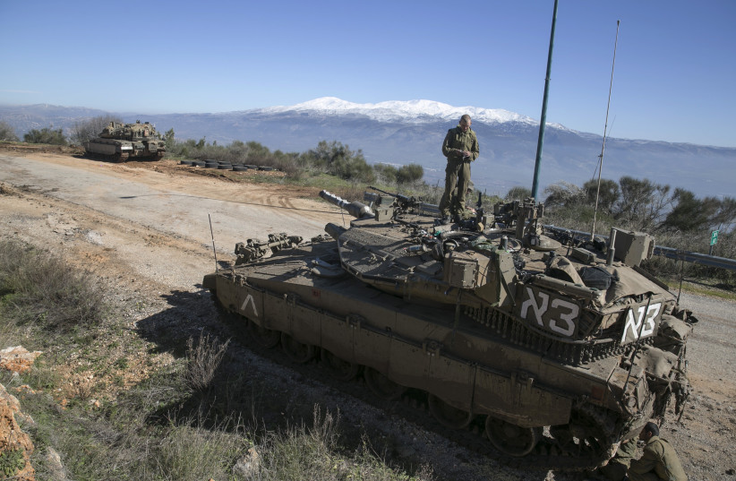An Israeli soldier stands atop a tank near Israel's border with Lebanon January 21, 2015. (photo credit: REUTERS)