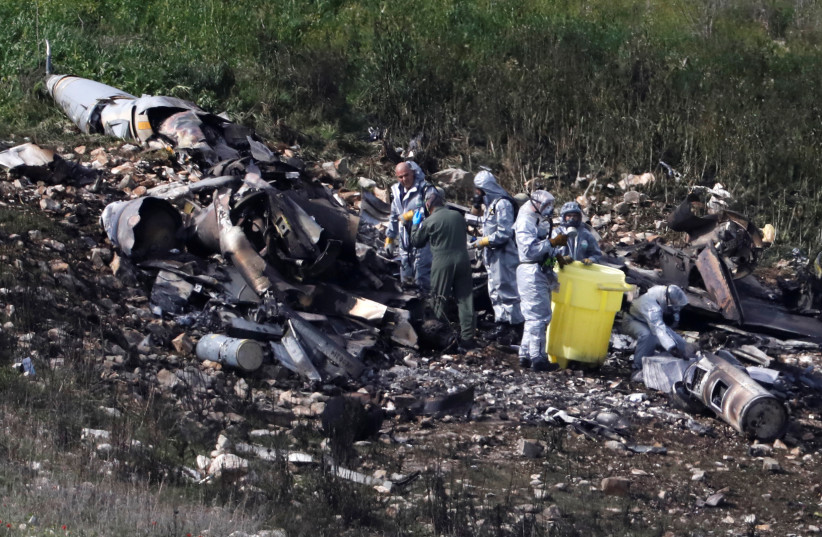 Israeli security forces examine the remains of an F-16 Israeli war plane near the village of Harduf (photo credit: RONEN ZVULUN/REUTERS)