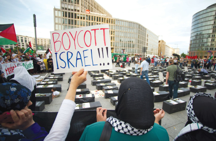ANTI-ISRAEL PROTESTERS with a ‘boycott Israel’ sign. (photo credit: REUTERS)