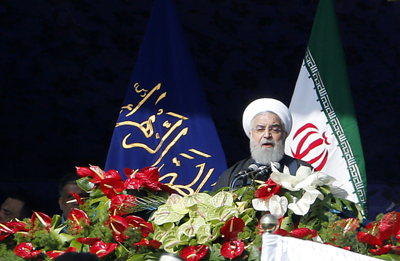 Iranian President Hassan Rouhani delivers a speech at the Azadi Square in the capital Tehran during a ceremony to mark the 39th anniversary of the Islamic revolution (photo credit: ATTA KENARE / AFP)