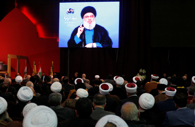 Lebanon's Hezbollah leader Sayyed Hassan Nasrallah is seen on a video screen as he addresses his supporters in Beirut, Lebanon February 16, 2018. (photo credit: REUTERS)