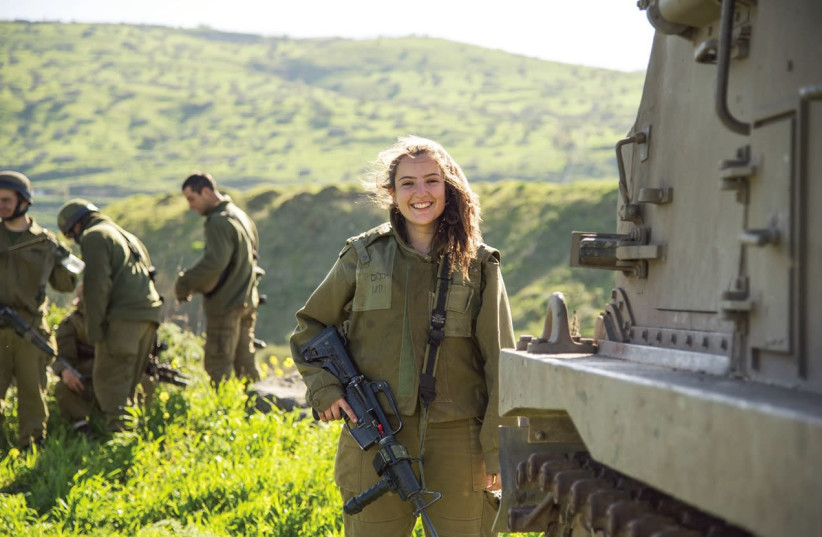 A woman combat soldier poses near the northern border a year ago during a joint exercise involving artillery, infantry and armored brigades (photo credit: EDEN BRIAND/IDF)