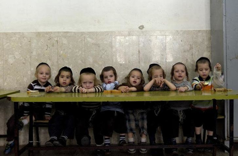Ultra-Orthodox Jewish children sit in class at the Shomrei HaHoma Torah School for boys in Jerusalem's Mea Shearim neighbourhood November 9, 2010 (photo credit: REUTERS/Ronen Zvulun)