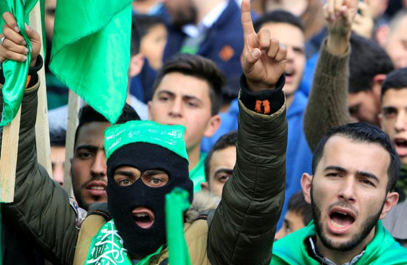Palestinian Hamas supporters shout slogans during a rally marking the 30th anniversary of Hamas' founding, in the West Bank city of Nablus December 15, 2017. REUTERS/Abed Omar Qusini (photo credit: ABED OMAR QUSINI/REUTERS)