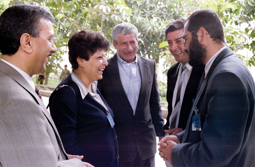 Leila Khaled smiles while talking to delegates outside a Palestinian National Council meeting in the Gaza Strip in the 1990s (photo credit: REUTERS)