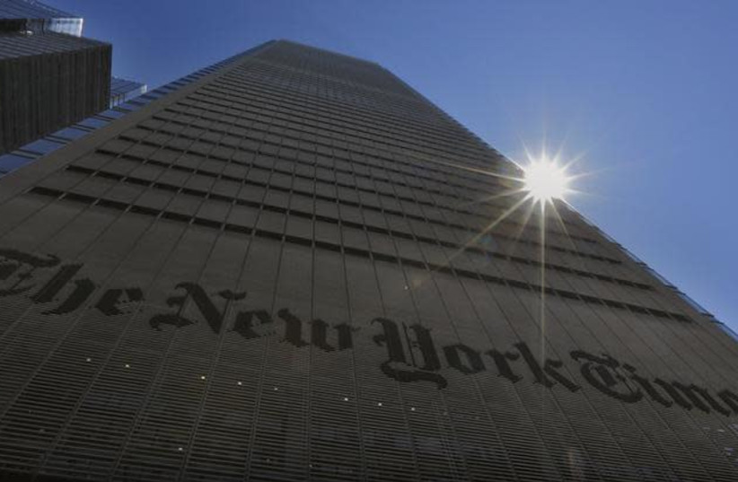 The sun peaks over the New York Times Building in New York August 14, 2013  (photo credit: BRENDAN MCDERMID/REUTERS)