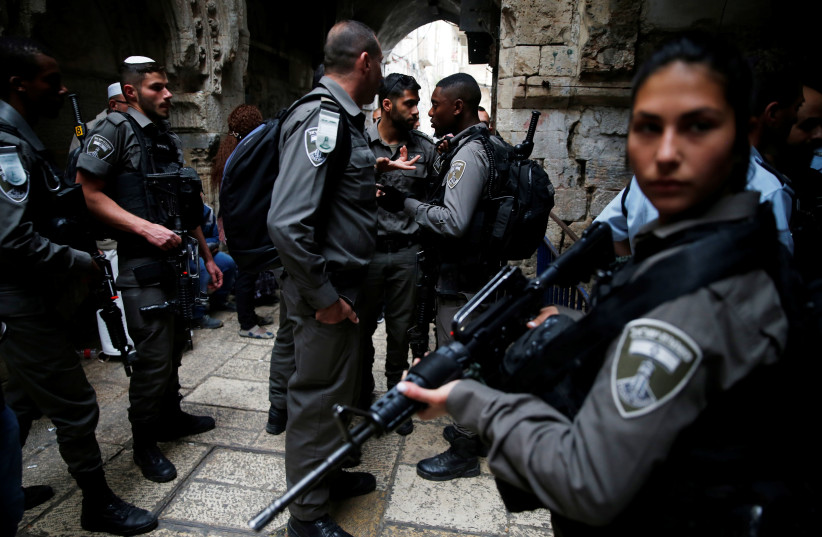 Israeli security forces stand at the site where an Israeli was killed in a stabbing attack in Jerusalem's Old City (photo credit: AMMAR AWAD / REUTERS)